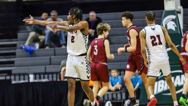 Detroit Old Redford's Kason Mayes points at the Riverview Gabriel Richard bench after a teammate makes a 3-pointer during the Michigan High School Athletic Association boys basketball Division 3 semifinals at Breslin Center in East Lansing on Thursday, March 14, 2024.